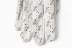 close up view of White cabretta leather golf glove with black trim, featuring repeating X pattern – The Redeemer Glove by 70x7 Golf Co. 