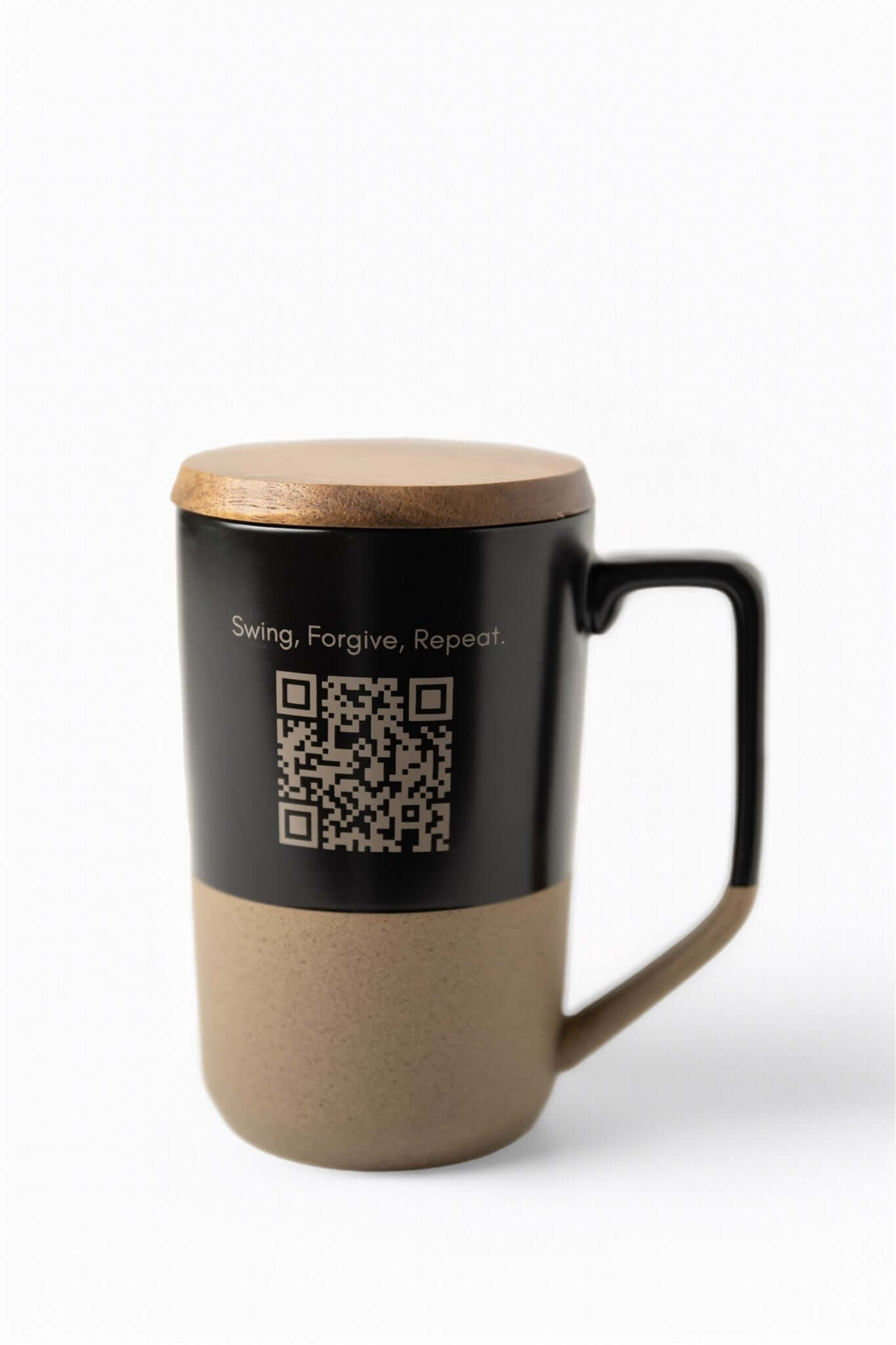 Back of ceramic mug with QR code and ‘Swing, Forgive, Repeat.’ text, shown with black upper half and tan base – The Morning Round Mug from 70x7 Golf Co.