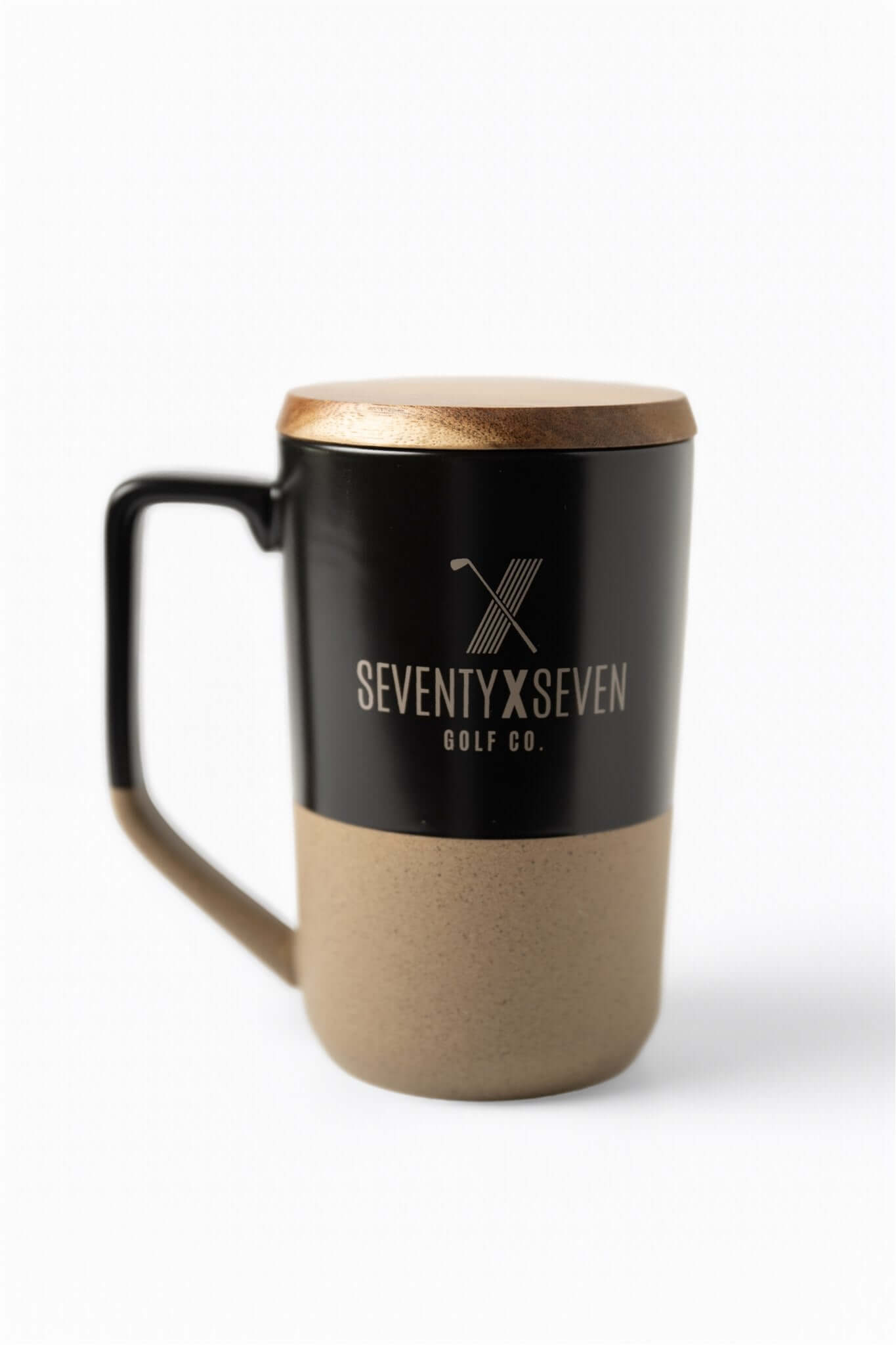 Dual-tone ceramic mug with black top, tan bottom, wooden lid, and SEVENTY X SEVEN Golf Co. logo on front – The Morning Round Mug by 70x7 Golf Co.