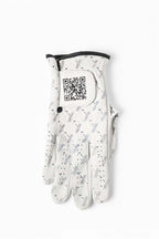 White cabretta leather golf glove with black trim, featuring repeating X pattern and visible QR code on wrist tab – The Redeemer Glove by 70x7 Golf Co. 