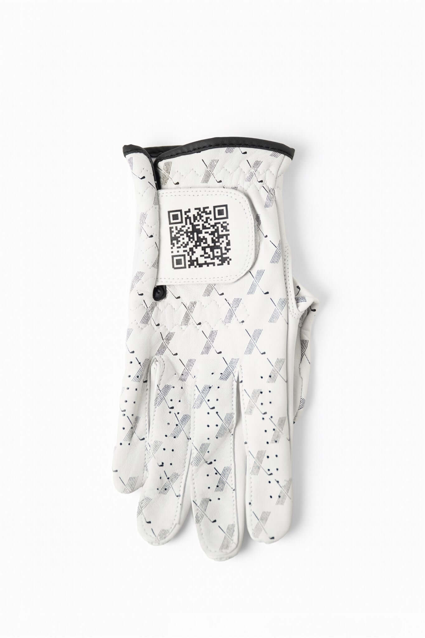 White cabretta leather golf glove with black trim, featuring repeating X pattern and visible QR code on wrist tab – The Redeemer Glove by 70x7 Golf Co. 