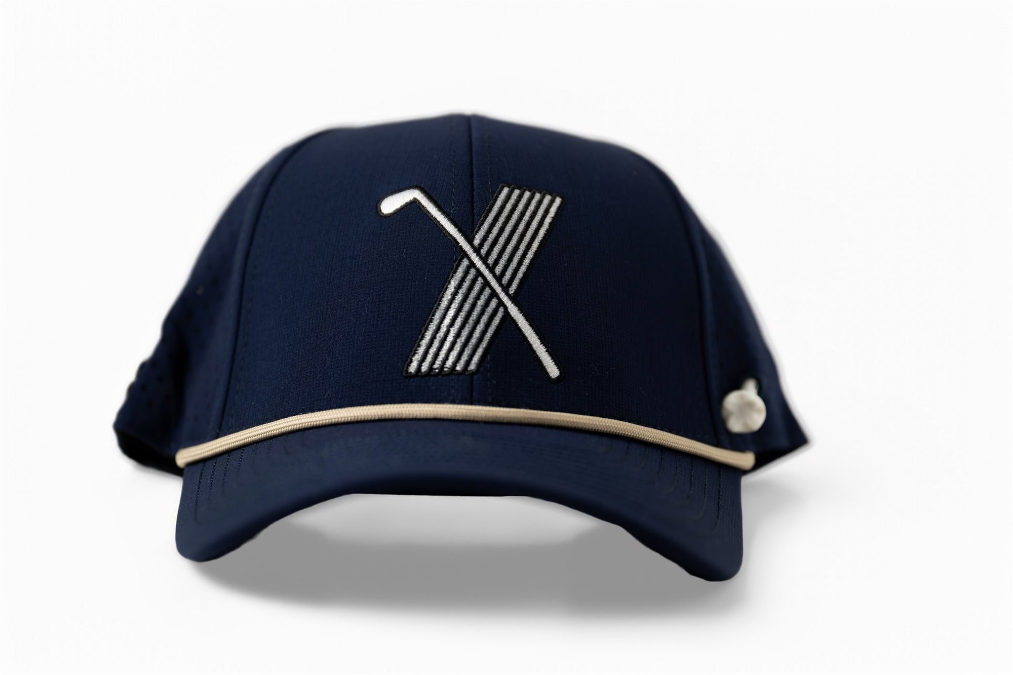 Navy blue golf hat with white embroidered X logo made of golf club and stripes, side view with contrast beige piping and perforated mesh back – The Quiet Lead Lid by 70x7 Golf Co.