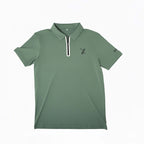 Green Forgiveness golf polo shirt with classic collar, zippered placket, 70x7 Golf Co. logo on chest, and SEVENTYXSEVEN text on sleeve