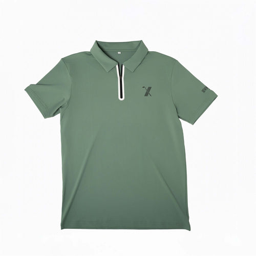 Green Forgiveness golf polo shirt with classic collar, zippered placket, 70x7 Golf Co. logo on chest, and SEVENTYXSEVEN text on sleeve